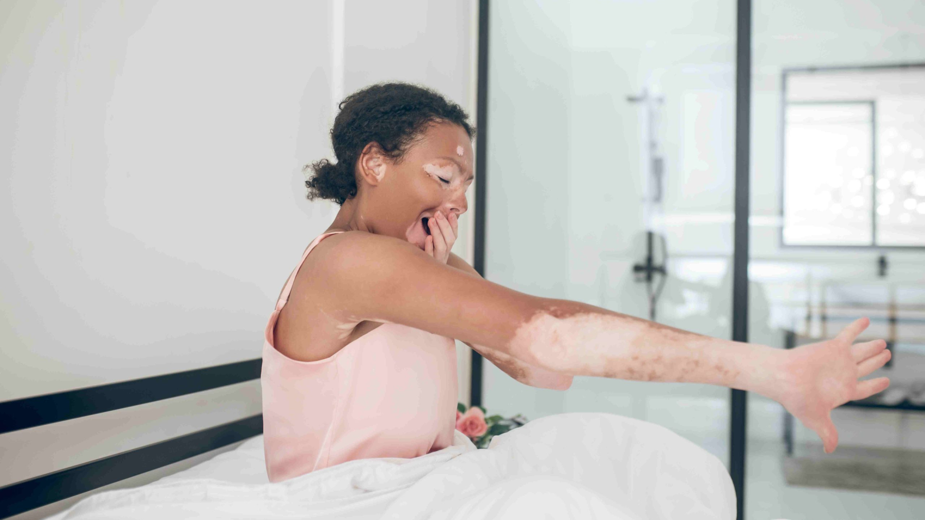 a-cute-young-mulatte-sitting-in-bed-and-looking-re-2024-10-16-23-13-13-utc_11zon