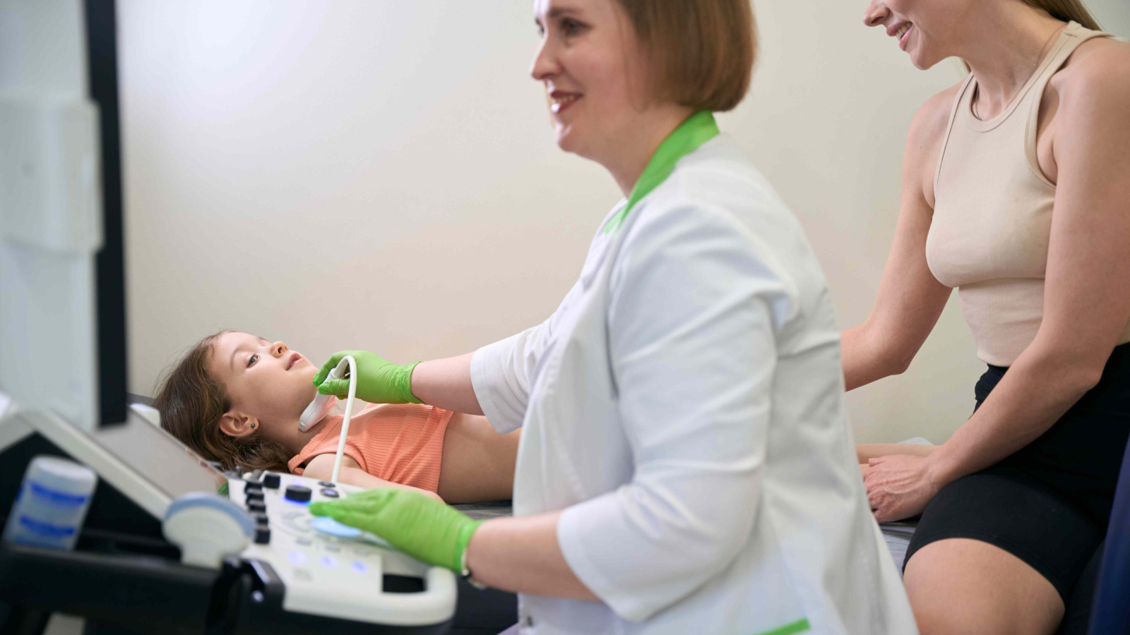 doctor-performing-ultrasound-on-a-child-while-moth-2024-10-20-00-28-25-utc_11zon