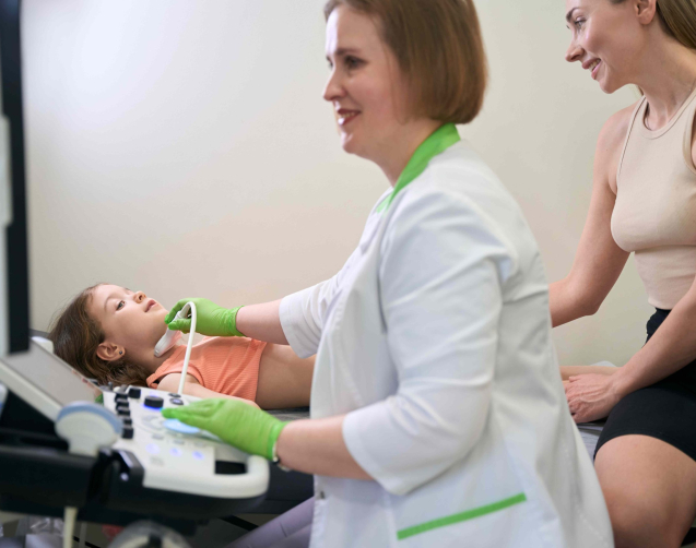 doctor-performing-ultrasound-on-a-child-while-moth-2024-10-20-00-28-25-utc_11zon